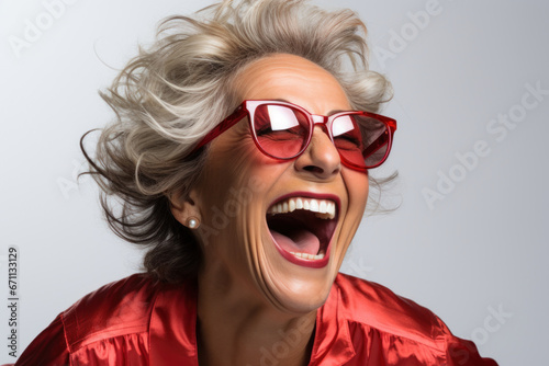 Senior woman laughing in Red sunglasses and in stylish clothes © paul