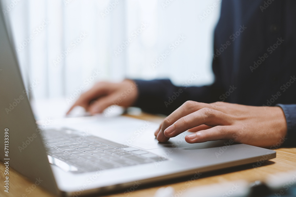 Hands of business person working on laptop at office desk, selective focus Hands of business person working on laptop at office desk, selective focus