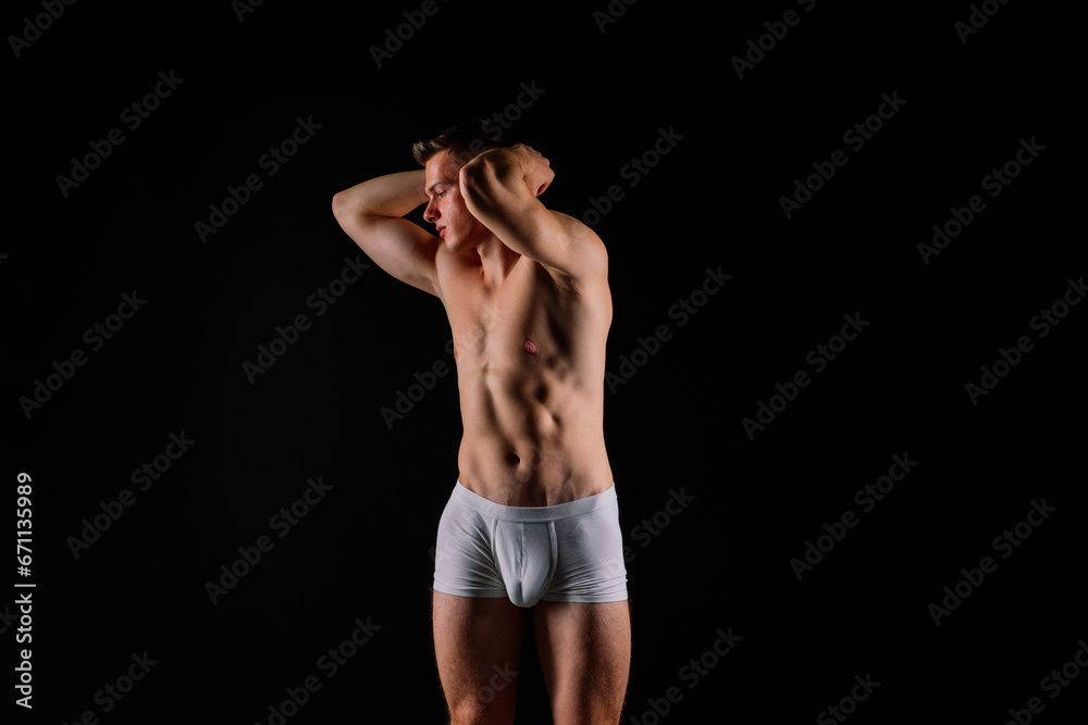 Portrait of young adult strong man in white briefs, studio shot. Sport and muscles Portrait of young adult strong man in white briefs, studio shot. Sport and muscles