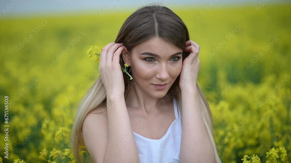 Girl in the field. Portrait of smiling woman. Woman in flower field outdoors. Yellow flowering field. Young female person in blooming garden. Girl in the field. Portrait of smiling woman. Woman in flower field outdoors. Yellow flowering field. Young female person in blooming garden.
