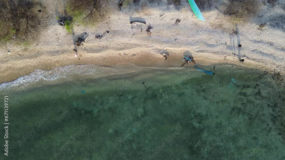 Aerial view of People bathing in the sun, swimming, and playing games ...