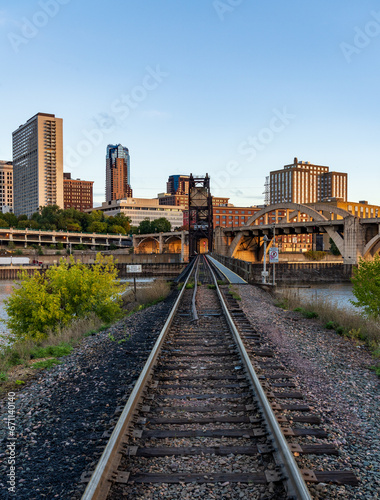 Early morning cityscape of St Paul and Twin Cities in Minnesota looking down rails of railroad bridge