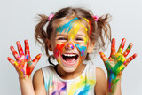 Cute girl laughs, gets dirty with paint. Photo of a happy child