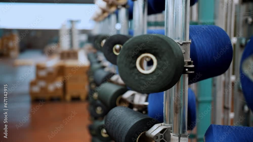 thread spools. close-up. racks with many thread spools. the process of preparing threads for dyeing, for the further production of fabrics of the desired color. automated work process. textile thread spools. close-up. racks with many thread spools. the process of preparing threads for dyeing, for the further production of fabrics of the desired color. automated work process. textile