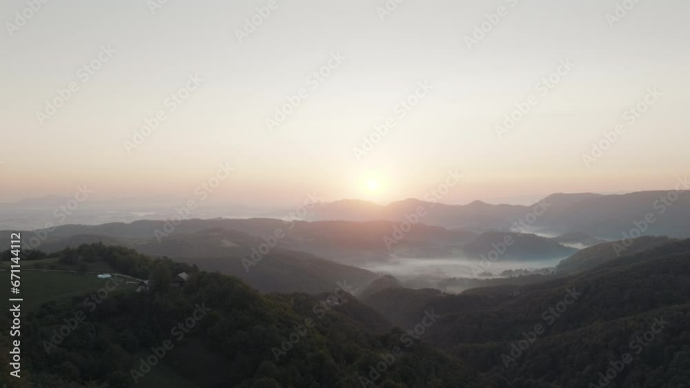 Mystic sunset over the green forest. Golden hour light. The sun is setting behind the mountains. Aerial view. Mystic sunset over the green forest. Golden hour light. The sun is setting behind the mountains. Aerial view.