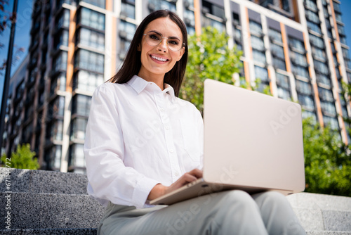 Photo of stunning elegant cheerful lady dressed white shirt glasses sitting park using modern netbook holidays weekend