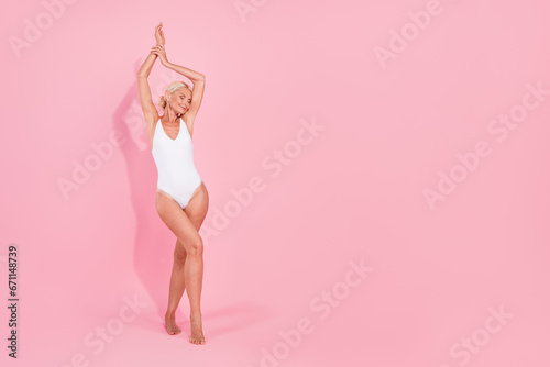 Photo of tender gentle pretty senior lady raise arms enjoy spa salon hygiene for perfect body isolated pastel color background