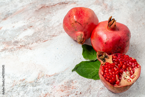 Several ripe pomegranate fruits and an open pomegranate, pomegranate on table, top view, dark background, Fresh ripe pomegranate on black background, selective focus, Healthy pomegranates fruit garnet