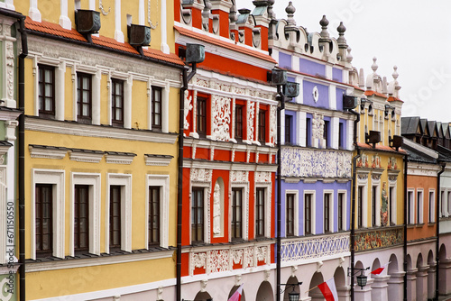 Richly decorated old Renaissance houses in the Polish town of Zamosc. Colorful old European houses, tourist attraction. Brightly painted facades of houses.