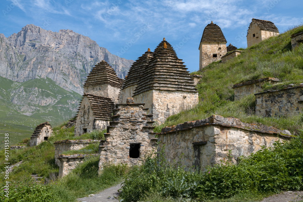 Ancient crypts in the city of the dead Dargavs on a sunny June day. North Ossetia-Alania, Russian Federation