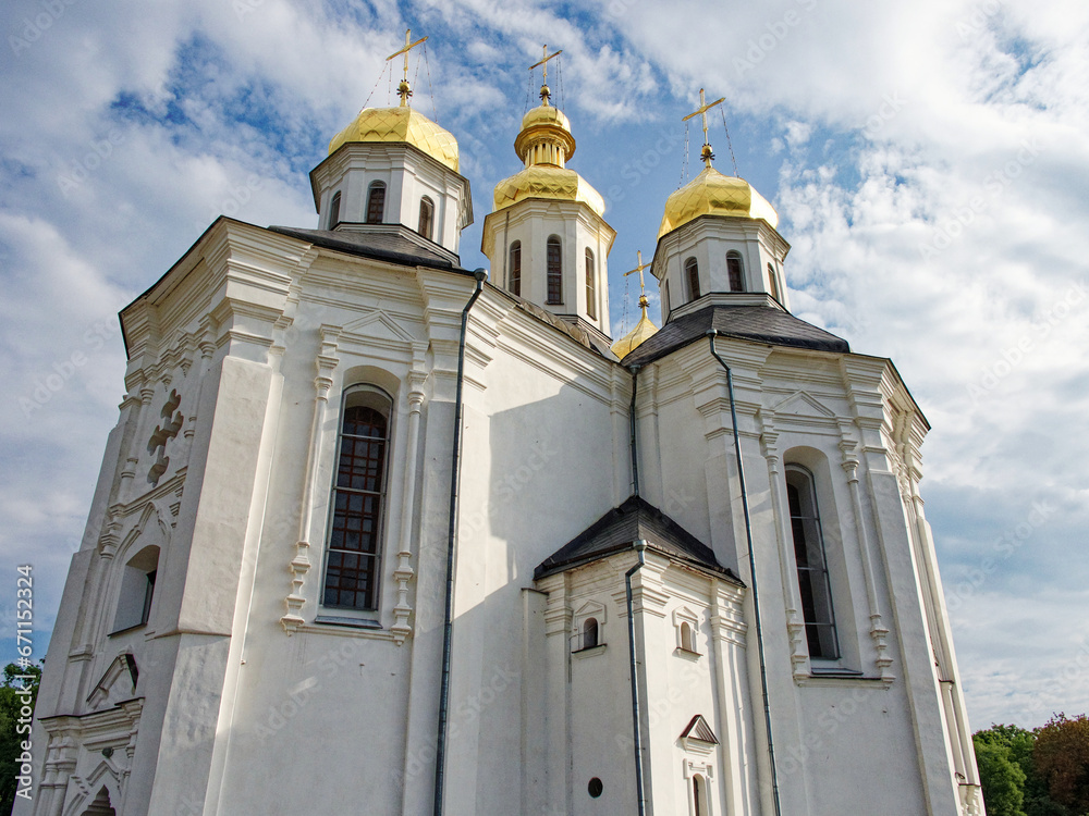 Fototapeta premium Catherine's Church in Chernihiv, an exquisite white Orthodox church adorned with glistening golden domes, showcases the essence of Ukrainian Baroque architecture, five resplendent domes.