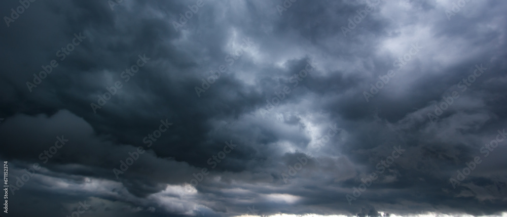 Bad or moody weather sky and environment. carbon dioxide emissions, greenhouse effect, global warming, climate change. The dark sky with heavy clouds converging and a violent storm before the rain. Bad or moody weather sky and environment. carbon dioxide emissions, greenhouse effect, global warming, climate change. The dark sky with heavy clouds converging and a violent storm before the rain.