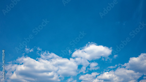 The canvas of the day is painted with a tranquil and serene blue sky  adorned with fluffy white cumulus clouds  offering a peaceful atmosphere.