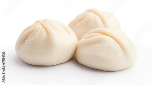 Three steamed dumplings on a white surface, bao buns. photo