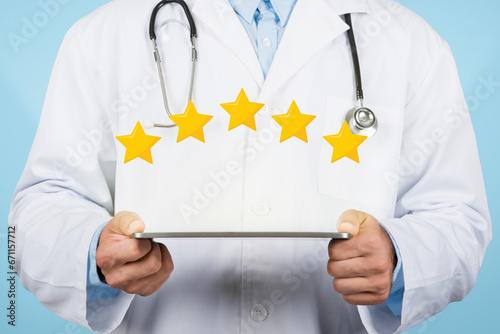 Doctor man holding tablet displaying five-star rating, blue background