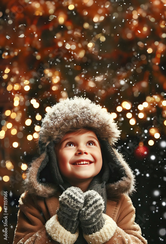happy child in warm clothes looking at a Christmas scene with snow and lights