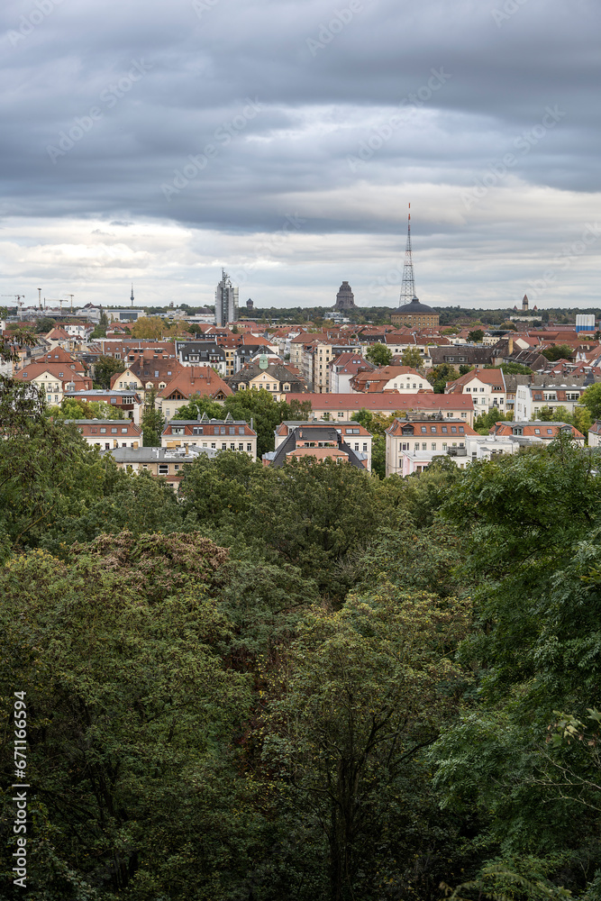 View of the city of Leipzig behind some trees, from Fockeberg.