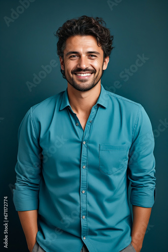 Man with beard and blue shirt smiling at the camera. © valentyn640
