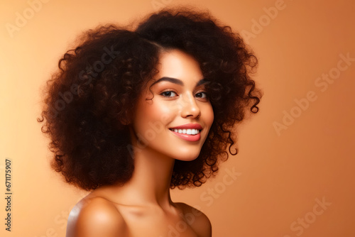 Woman with large afro is smiling for the camera.