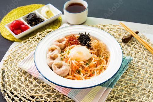 Spicy Hui Taizi Mixed Fish Udon noodles served in bowl isolated on napkin side view japanese food on table photo