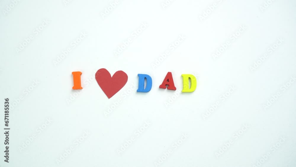 I Love Dad text from colorful wooden letters and a beating paper red heart. Congratulations on Father's day. I Love Dad text from colorful wooden letters and a beating paper red heart. Congratulations on Father's day.