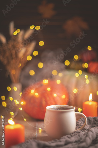 Autumn cozy composition. Tea in a mug, pumpkins and candles