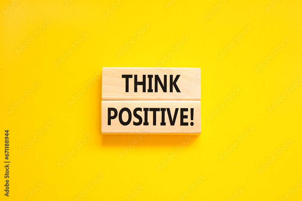 Think positive symbol. Concept words Think positive on beautiful wooden block. Beautiful yellow table yellow background. Business, motivational think positive thinking concept. Copy space. Think positive symbol. Concept words Think positive on beautiful wooden block. Beautiful yellow table yellow background. Business, motivational think positive thinking concept. Copy space.