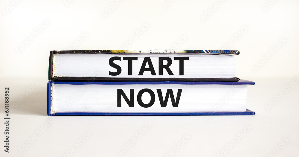 Start now symbol. Concept words Start now on beautiful books. Beautiful white table white background. Business marketing, motivational start now concept. Copy space.