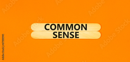Common sense symbol. Concept words Common sense on wooden stick. Beautiful orange table orange background. Business, motivational common sense concept. Copy space.