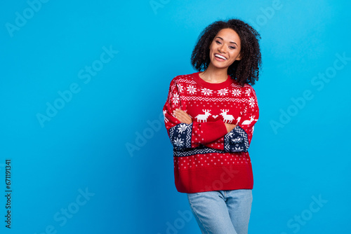 Photo of young lady folded hands enjoying outfit for christmas eve party wearing ugly sweater with jeans isolated on blue color background