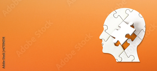 Brain shaped white jigsaw puzzle on colored background. Mental health and problems with memory.