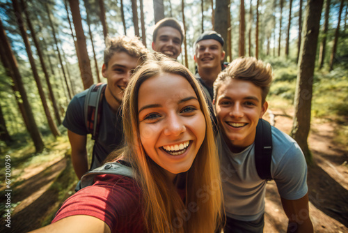 A wide angle selfie of a group of happy young friends in the forest © Adrian Grosu
