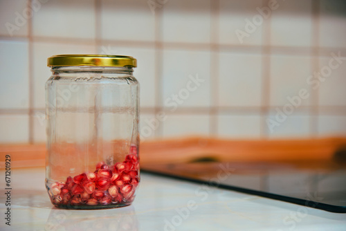 glass jar with pomegranate seeds