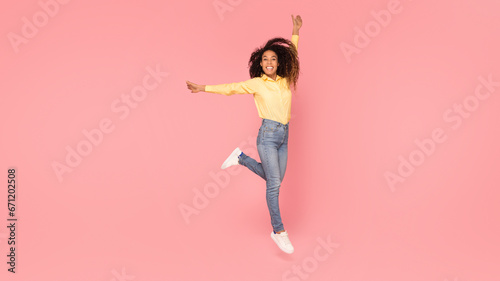 Elegant black lady posing against pink backdrop