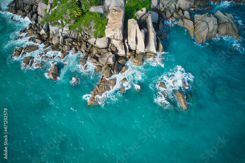 Bird eye drone shot of north east point beach, granite rocks, turquoise water, waves crashing, greenery, Mahe Seychelles 7