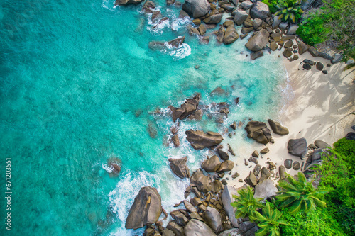 Bird eye drone shot of north east point beach, small hidden white sandy beach with granite rocks, turquoise water, waves crashing, grenery, Mahe Seychelles 1