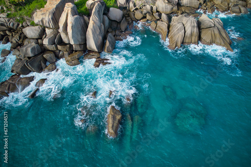 Bird eye drone shot of north east point beach, granite rocks, turquoise water, waves crashing, grenery, Mahe Seychelles 9