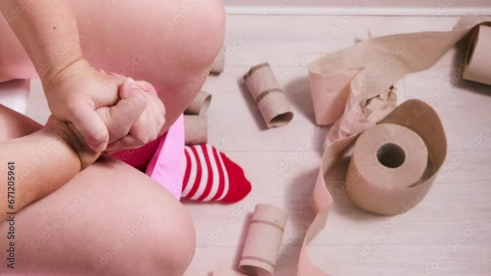 woman sitting on toilet with toilet paper and suffering from