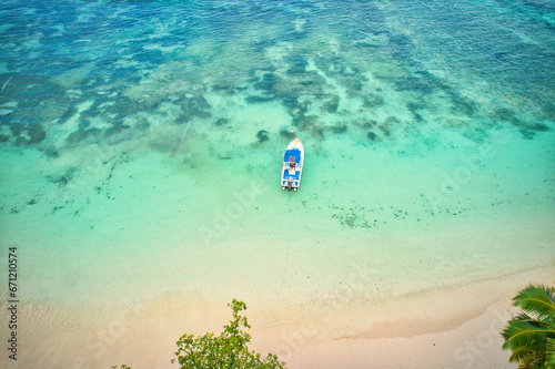 Drone of baie lazare beach, docking fisherman boat on low tide near the shore, turquoise water, sunny day, Mahe Seychelles 1