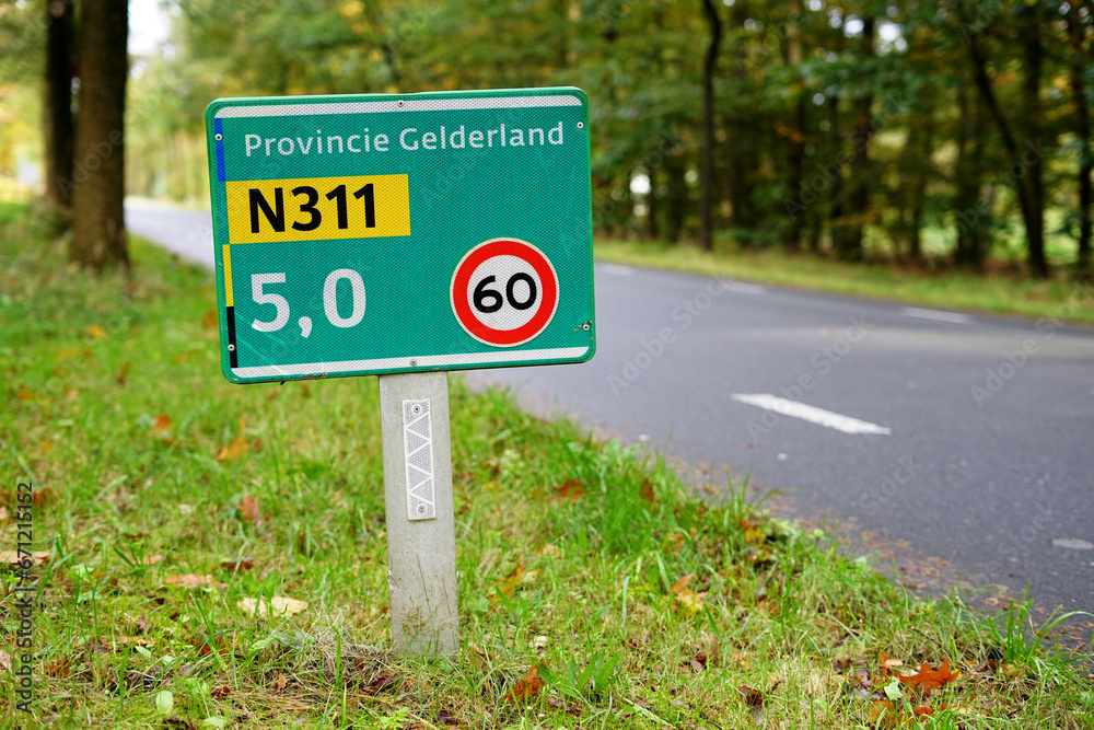 Street name sign at the provincial road N311 'Koningsweg' near Dutch city of Arnhem, with maximum speed in kilometer written