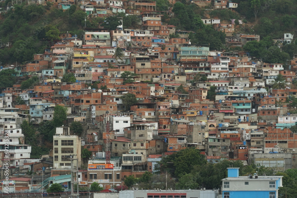 Suburb with poor family houses of La Guaira town near Caracas showing poverty and is situated on hill near commercial merchant port. View from container terminal. Suburb with poor family houses of La Guaira town near Caracas showing poverty and is situated on hill near commercial merchant port. View from container terminal.