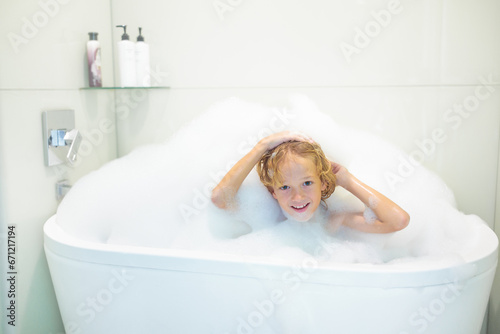 Child playing with foam in bath