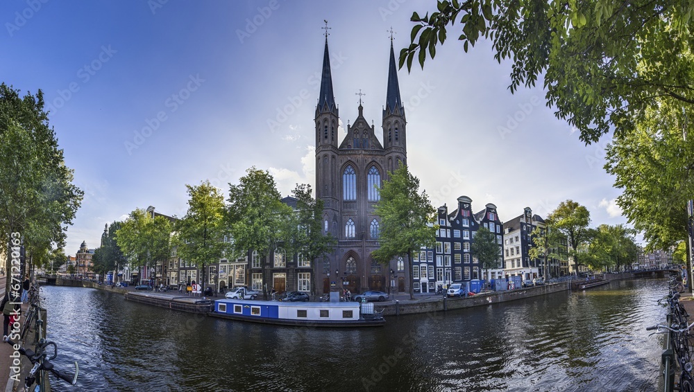 Picture of St Francis Xavier Church in Amsterdam with adjacent canal in summer 2023