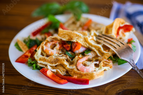 Fried simple omelet with shrimp and vegetables in a plate.