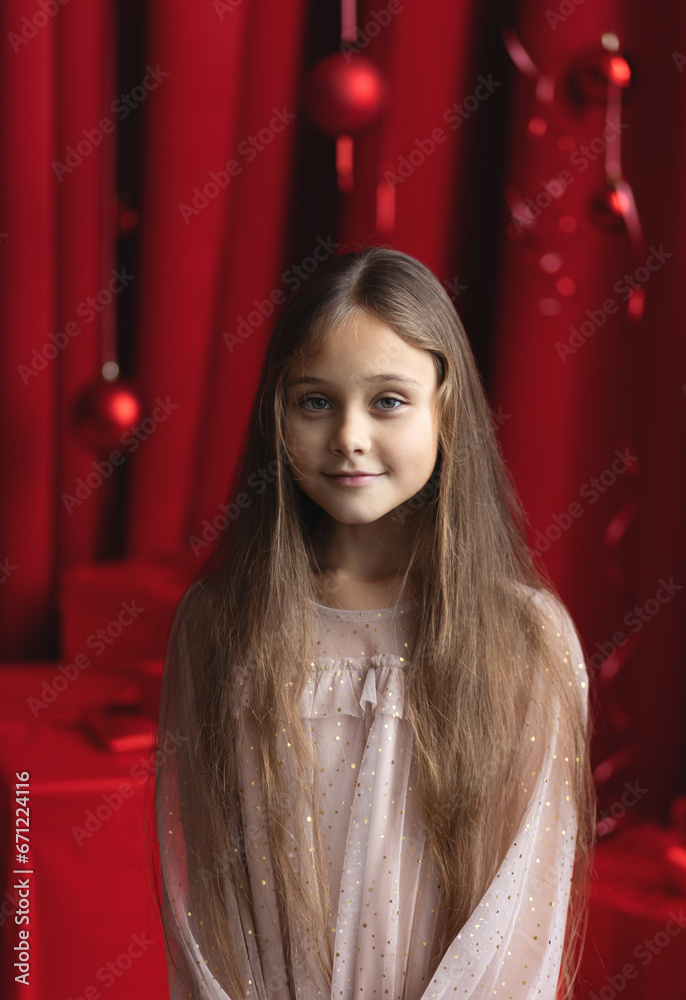 close up portrait of Cute little girl with long hair in dress on the  background Christmas. Xmas holiday concept