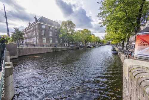 View over a typical canal in the Dutch metropolis Amsterdam in summer 2023 © Aquarius