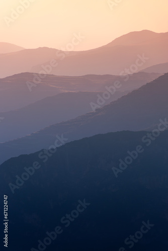 Beautiful layered blue mountains, transitioning into the sunset vetical