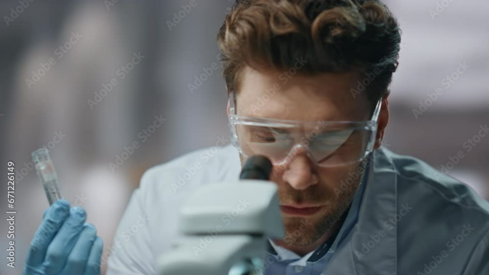Closeup scientist examining medicines in biochemistry laboratory in test tube Closeup scientist examining medicines in biochemistry laboratory in test tube