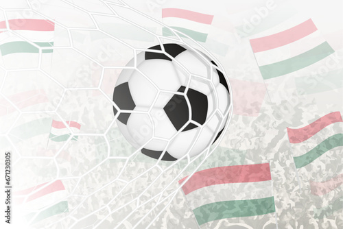 National Football team of Hungary scored goal. Ball in goal net, while football supporters are waving the Hungary flag in the background.