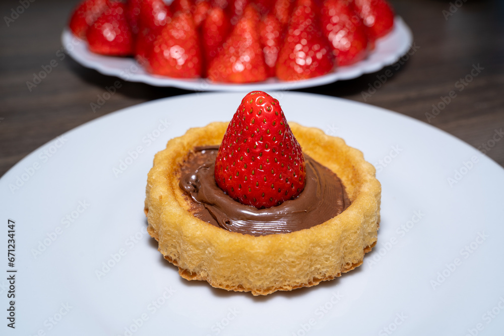 Little cake with a strawberry and chocolate cream Little cake with a strawberry and chocolate cream